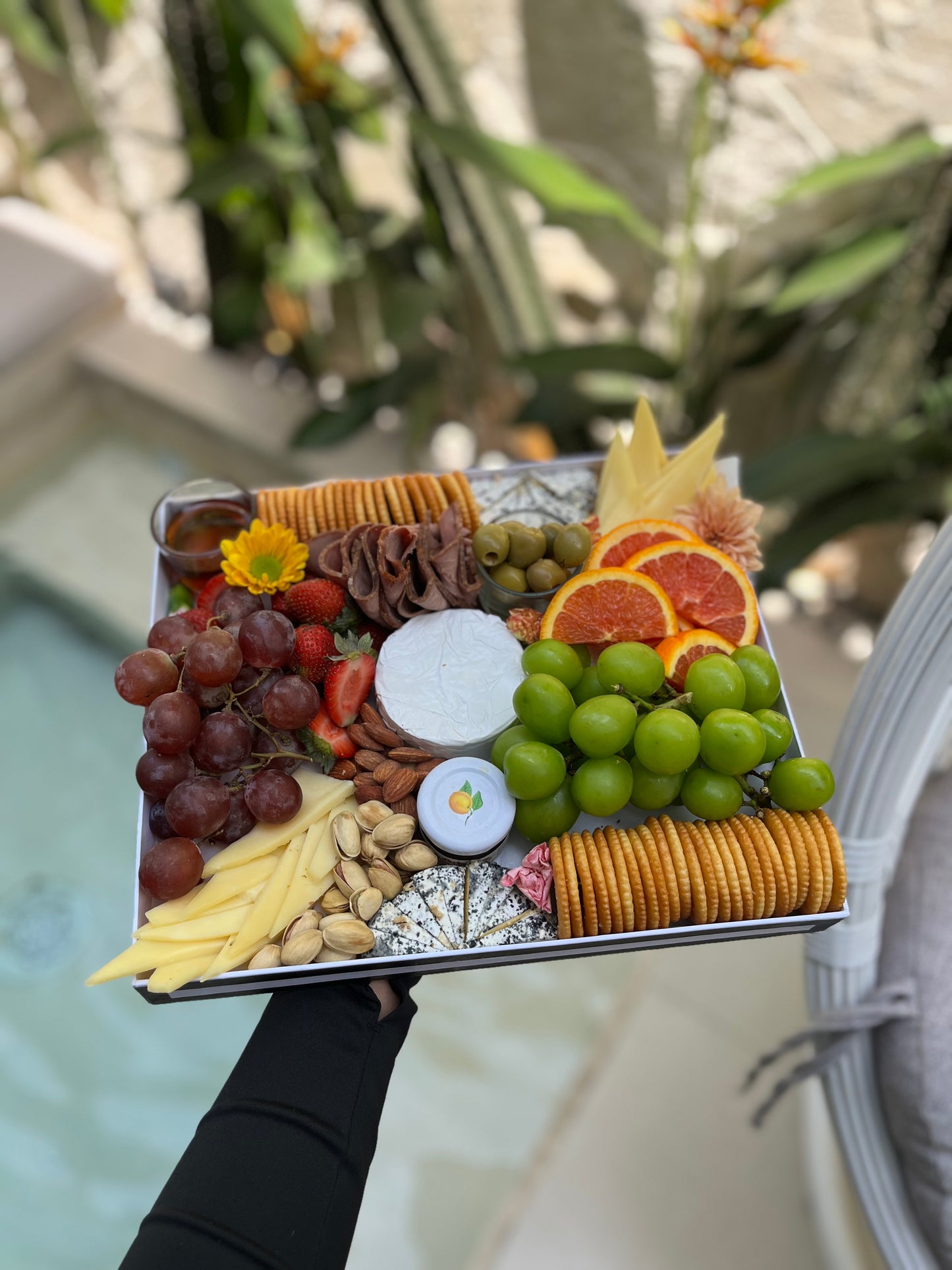 Cheese and fruit platter with assorted cheeses, grapes, and strawberries in Jakart