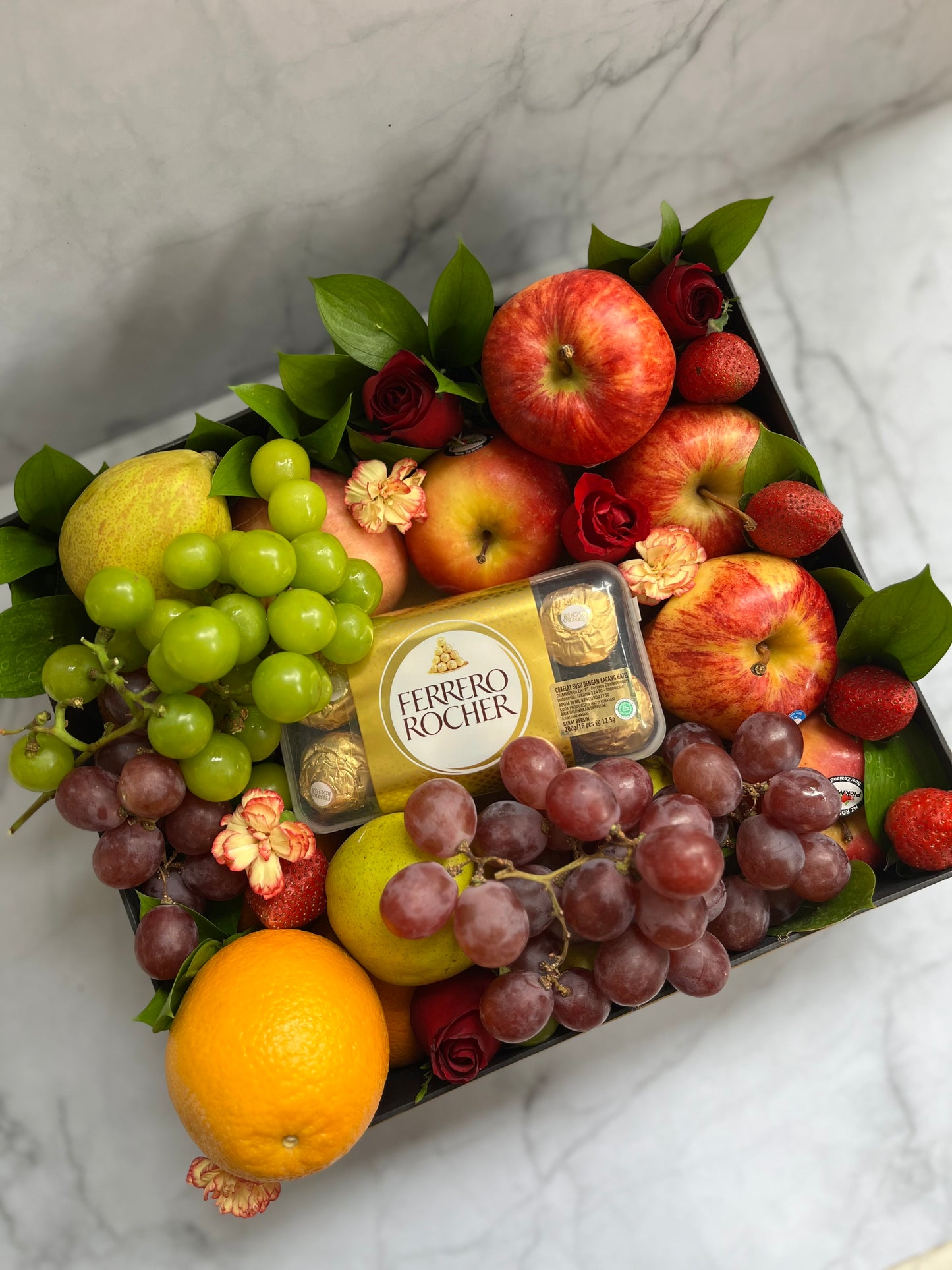 Luxury fruit hamper in Jakarta featuring a fruit box with imported seasonal fruits and Ferrero Rocher chocolates
