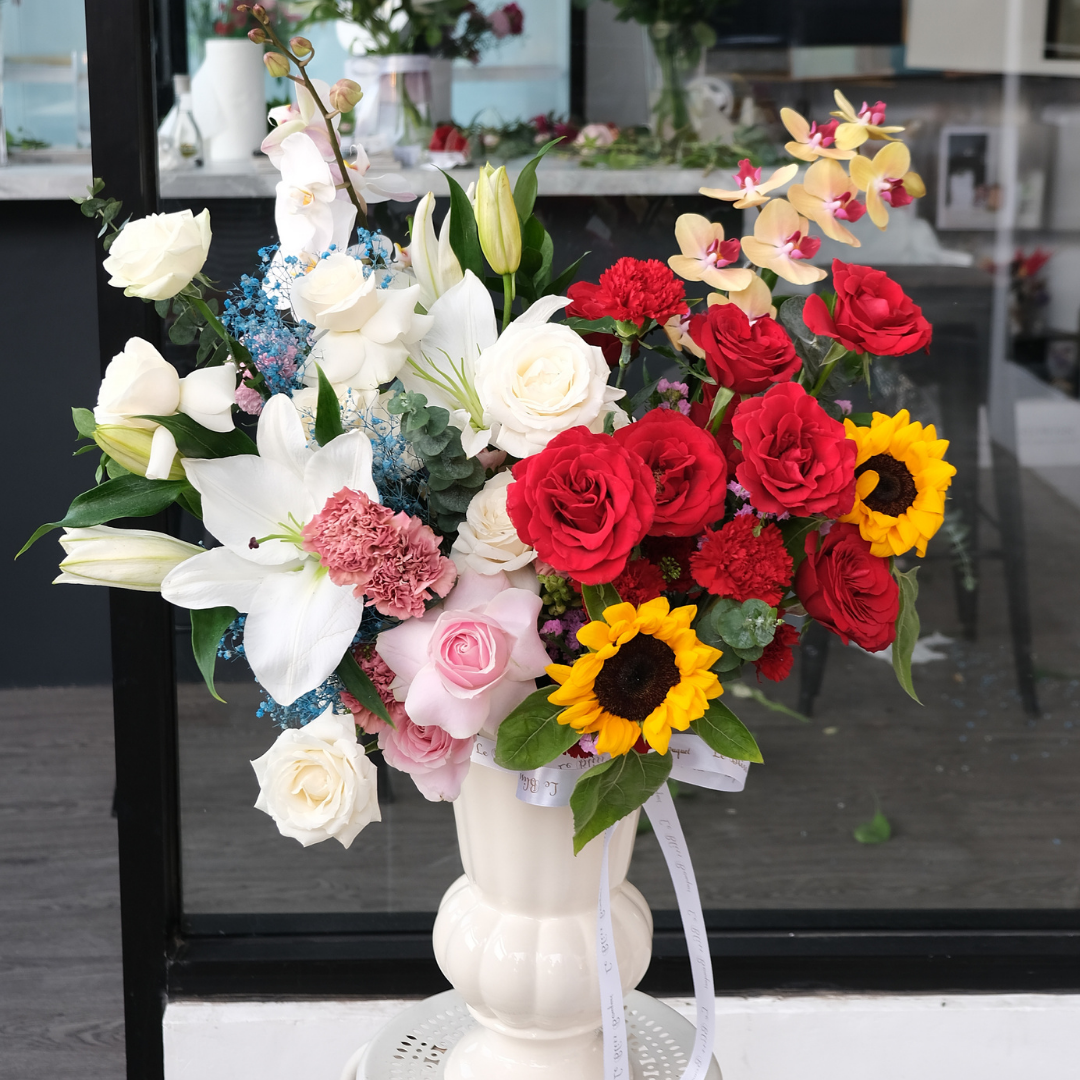 orchid sunflower rose vase arrangement by le bliss bouquet jakarta