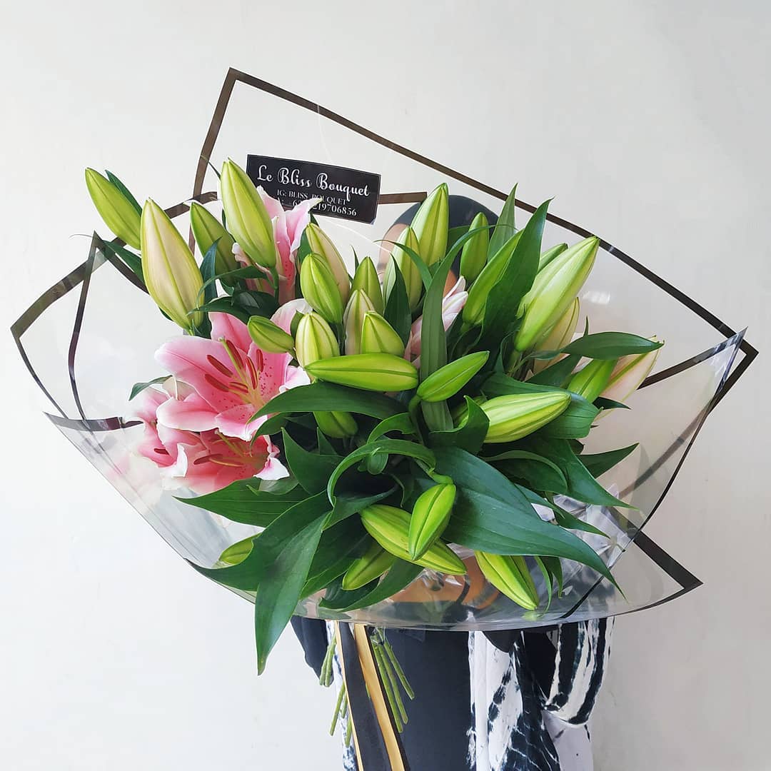 A bouquet of pink Casablanca lilies wrapped in clear paper by Le Bliss Bouquet. florist surabaya, flower delivery surabaya, bouquet surabaya
