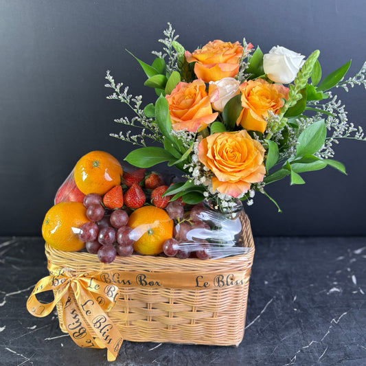 Basket with flowers and fruits on a dark surface. Parcel buah surabaya dengan bunga rose ecuador free spirit rose by le bliss bouquet