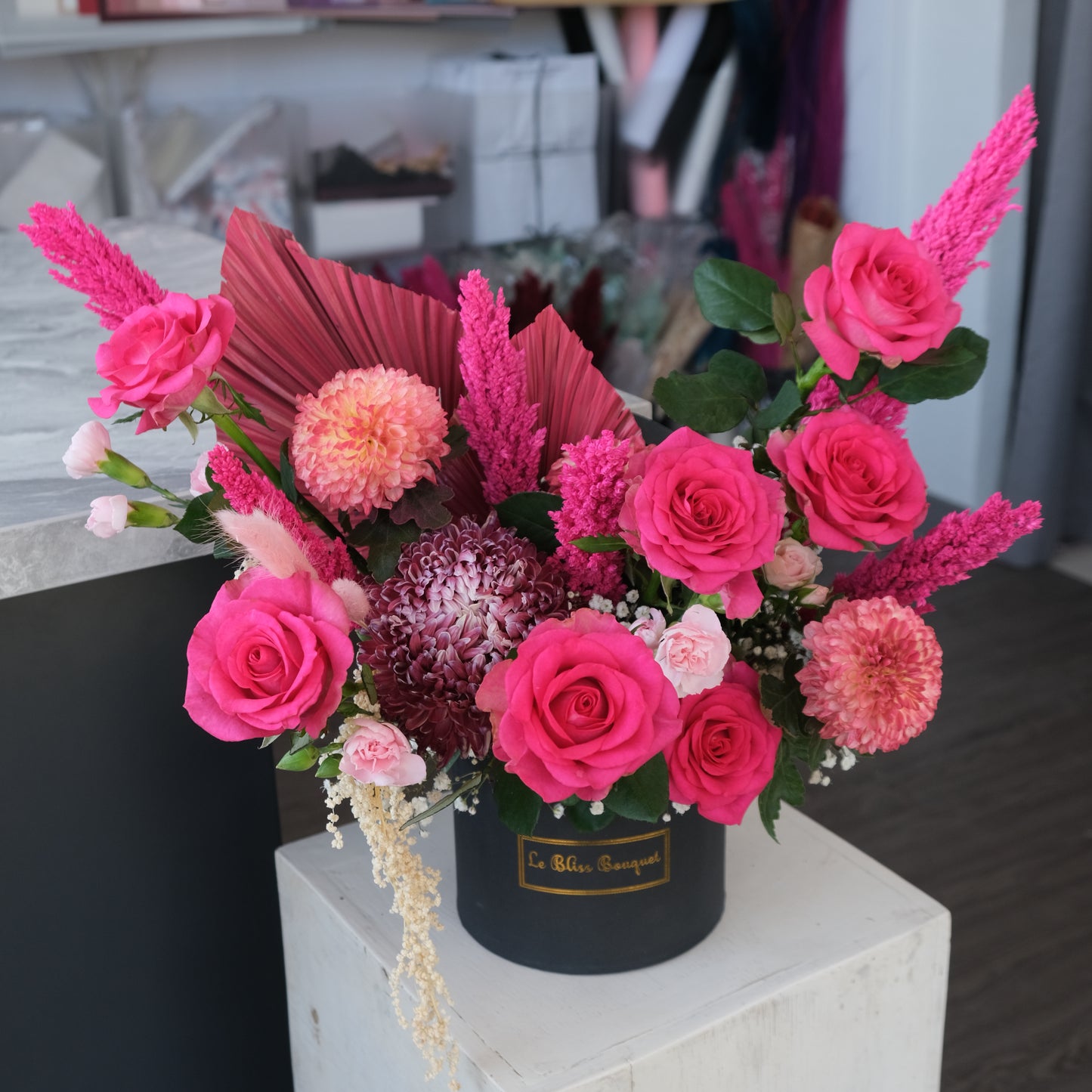 A Pink Fanta Barbie Petite Bloombox floral arrangement with pink roses, peony mums, and other flowers in a black box. Florist Surabaya, toko bunga surabaya, le bliss bouquet surabaya