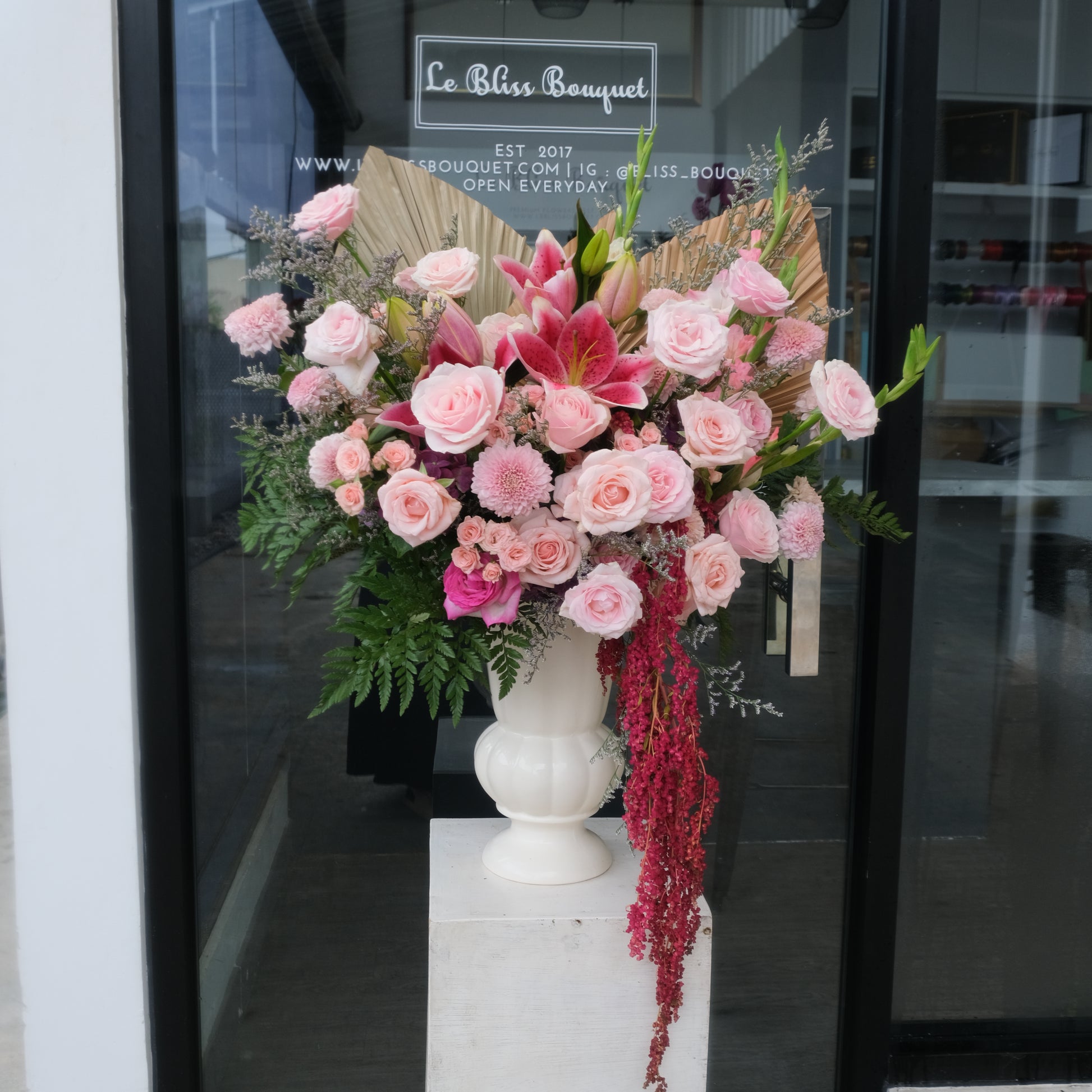 A vase arrangement featuring a variety of pink flowers, including roses and lilies, with greenery by Le Bliss Bouquet. Florist surabaya, le bliss bouquet surabaya