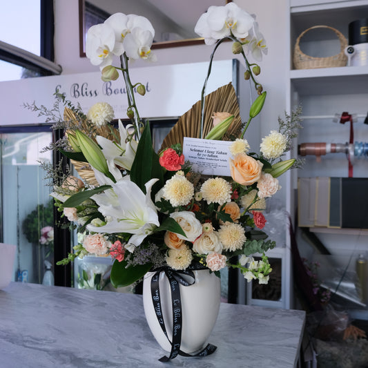Double orchid vase with white lilies and orange flowers from florist Surabaya, available for delivery to Cirebon, Jabodetabek, Sidoarjo, Gresik, and Majalengka.