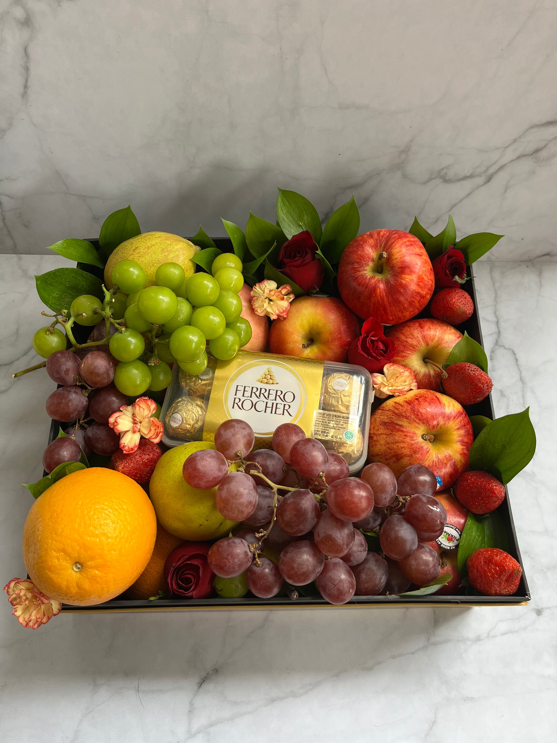 Luxury fruit hamper in Jakarta featuring a fruit box with imported seasonal fruits and Ferrero Rocher chocolates