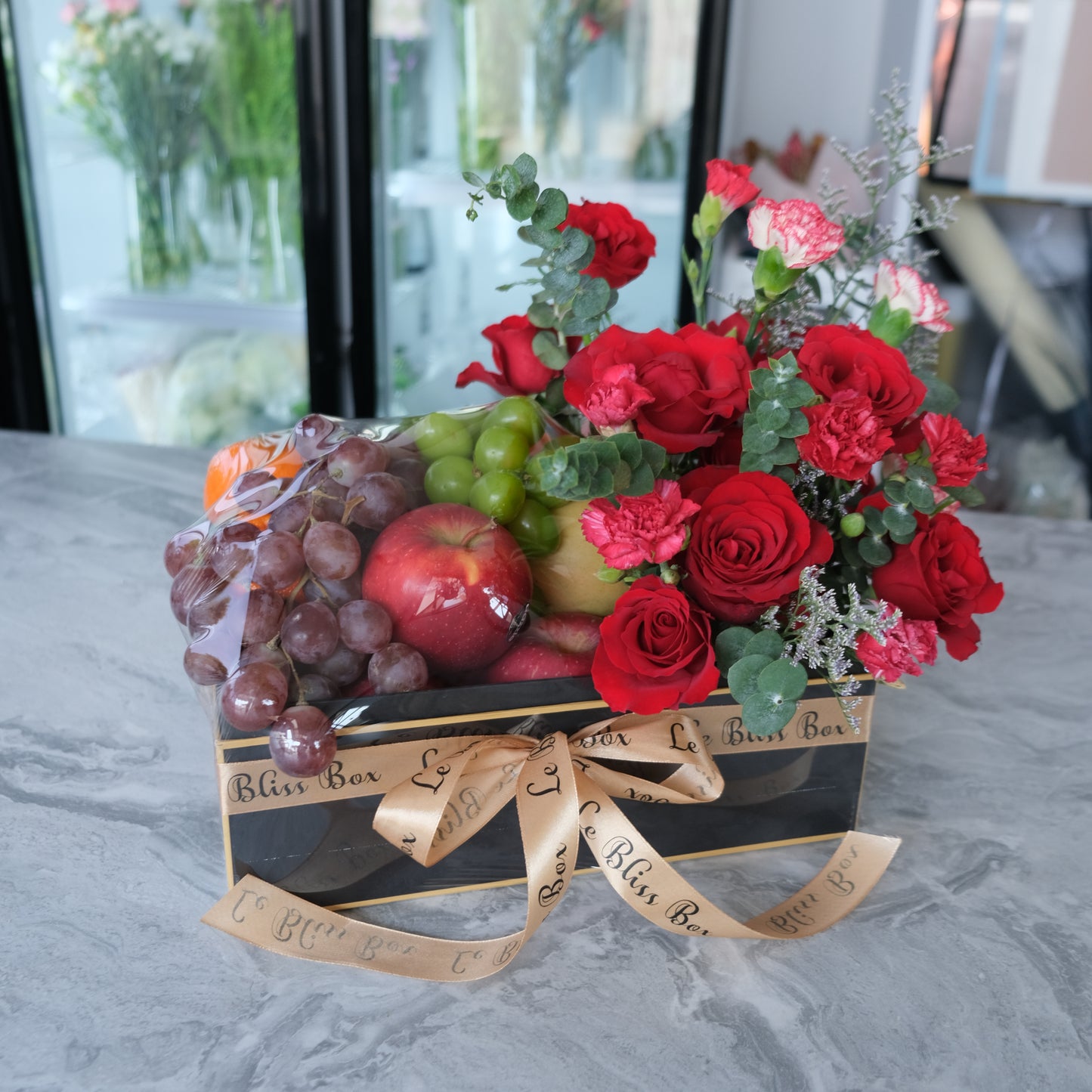 Festive Christmas Bloom Fruit Box filled with fresh premium fruits and beautiful festive blooms, perfect for Christmas celebrations. fruit hamper jakarta, surabaya