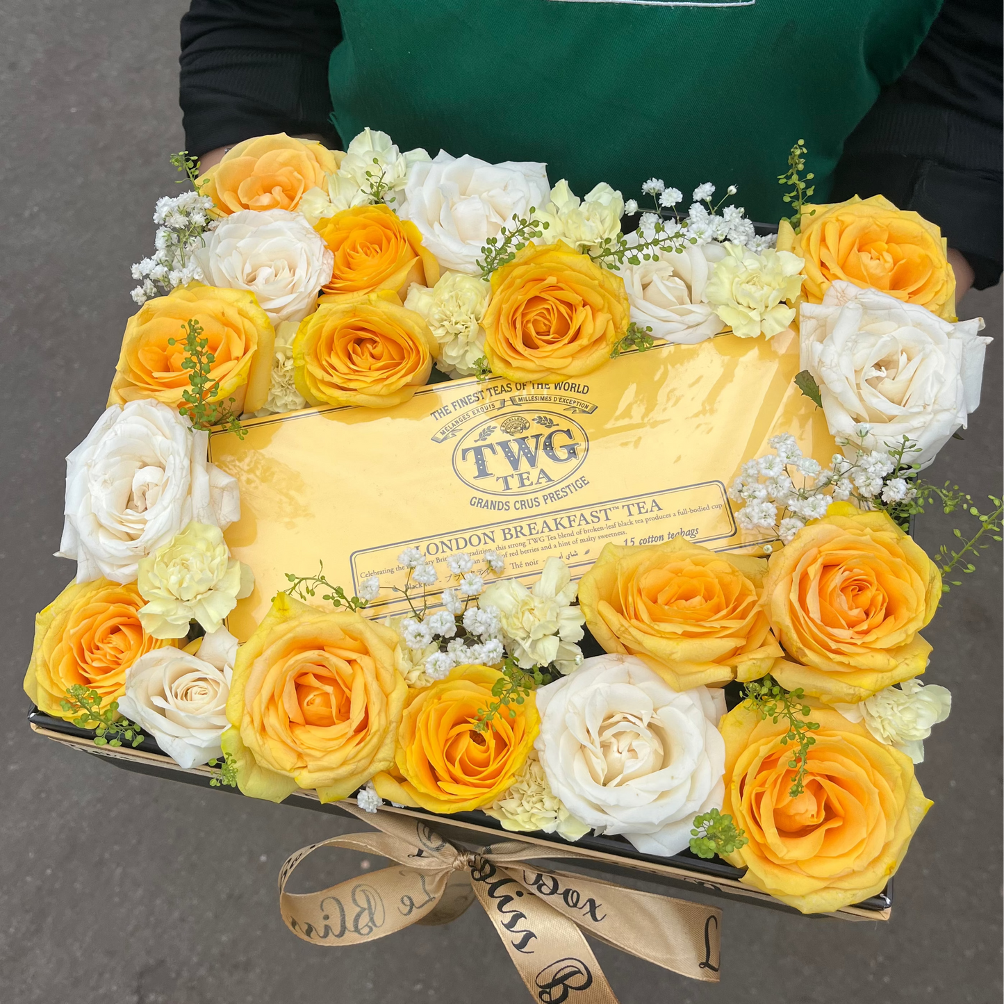 Floral arrangement with TWG Tea box and 'Le Bliss Box' branding in the background. TWG TEA HAMPER JAKARTA, SURABAYA, INDONESIA