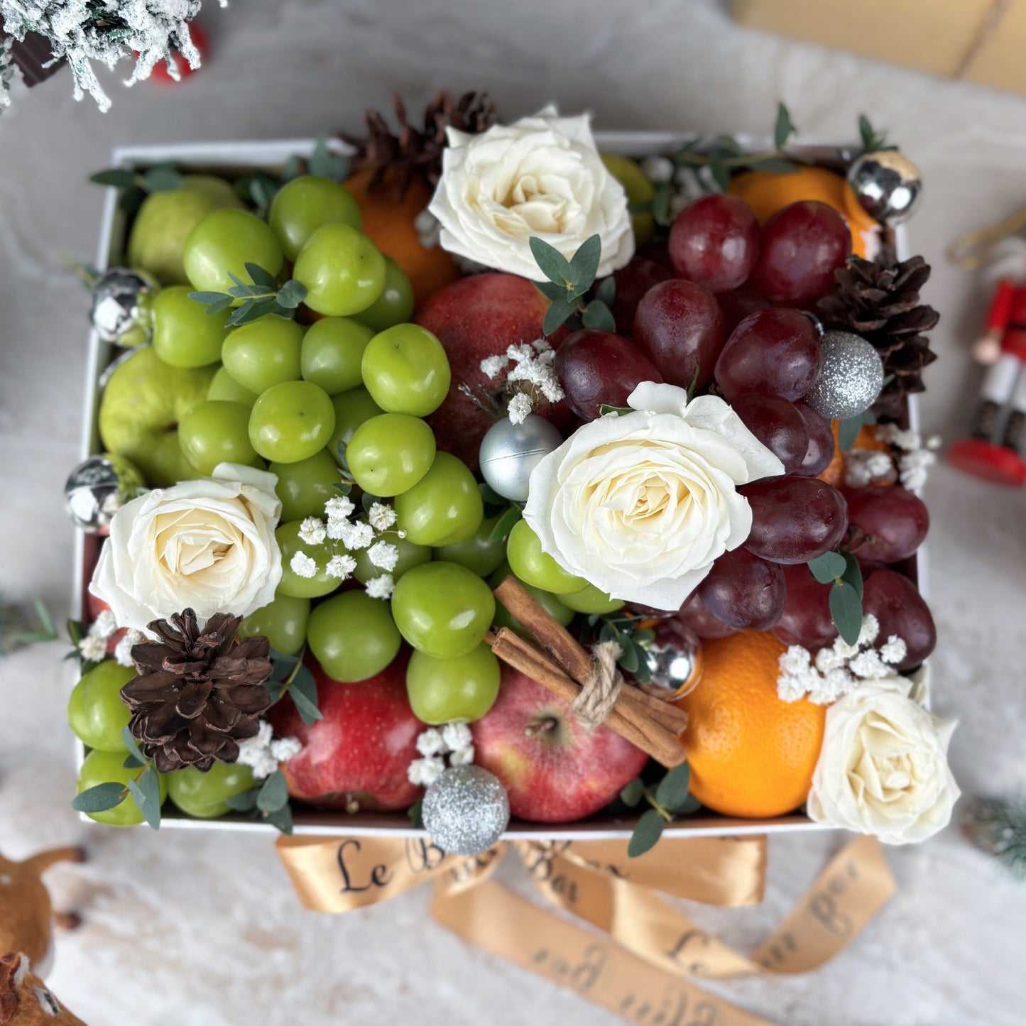 Fruit and flower arrangement in a box with decorative elements on a festive background. Parcel natal jakarta, Parcel natal surabaya, parcel natal cirebon
