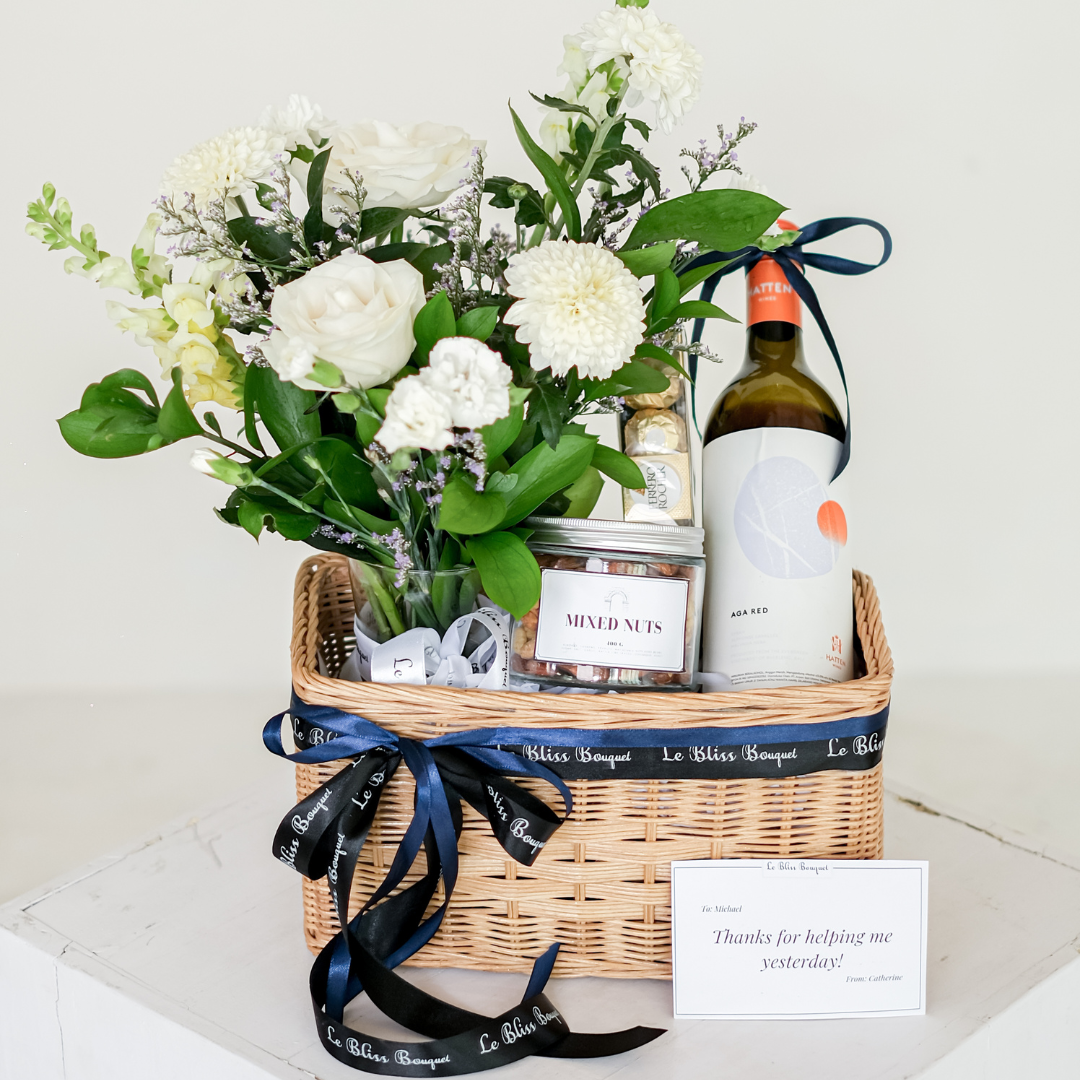 wine hamper surabaya, wine hamper jakarta by le bliss. hate wine, mixed nuts, Ferrero, and fresh flowers in vase
