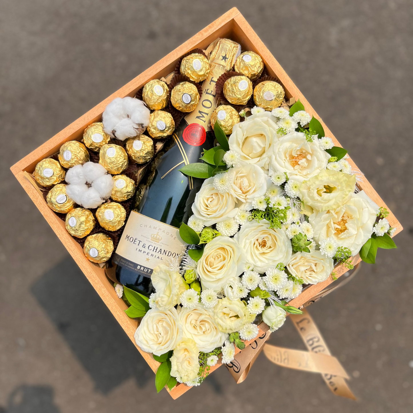 Gift box with Moet & Chandon champagne, white roses, and Ferrero Rocher chocolates. wine hamper jakarta, surabaya, champagne hamper jakarta. moet with fresh flower gift bo