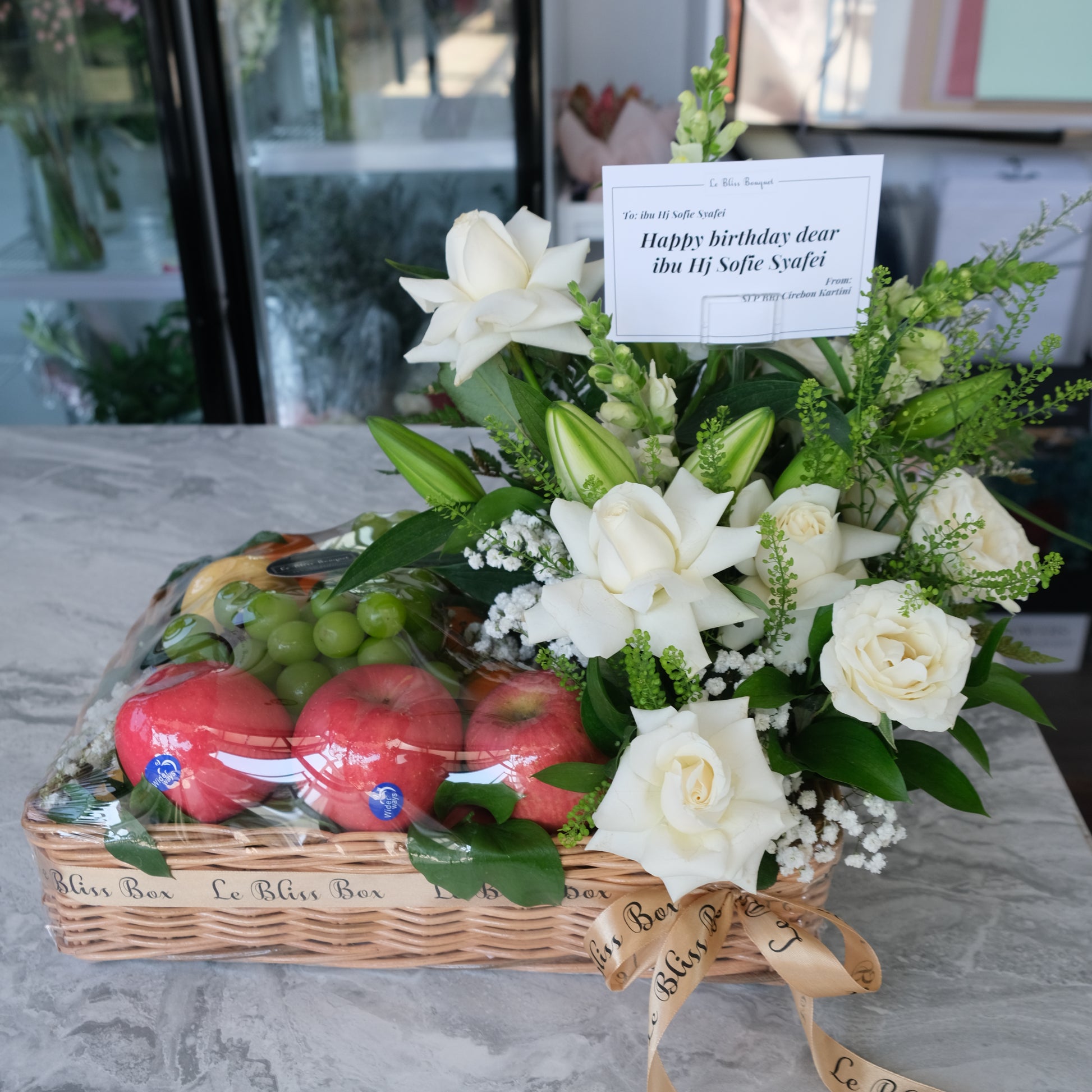 Grand Rattan fruit Parcel with white roses and lilies by le bliss box | parcel buah surabaya, hamper buah surabaya