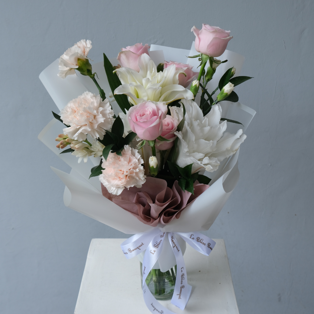 Hand-tied bouquet featuring Roselily, Holland carnations, and roses, no vase needed, perfect for celebrations, available with free greeting card.