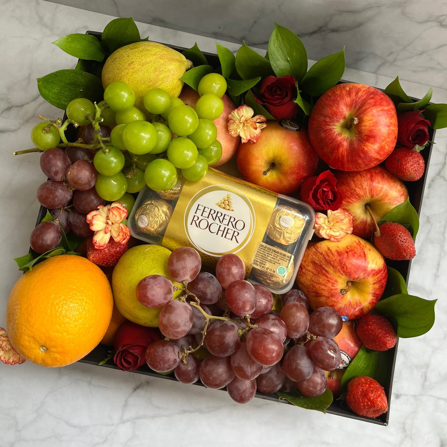 Luxury fruit hamper in Jakarta featuring a fruit box with imported seasonal fruits and Ferrero Rocher chocolates. fruit hamper jakarta