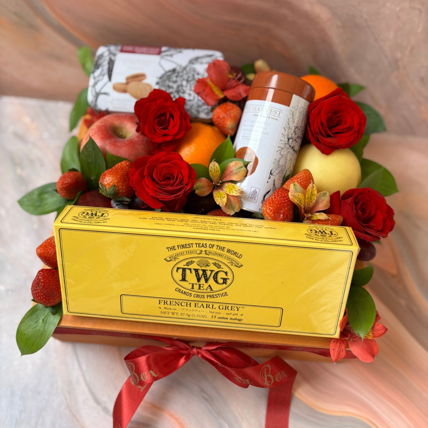 Luxury hamper with TWG Tea, cookies, and imported fresh fruits in a rustic wooden box, gift-ready by Le Bliss Box Jakarta.