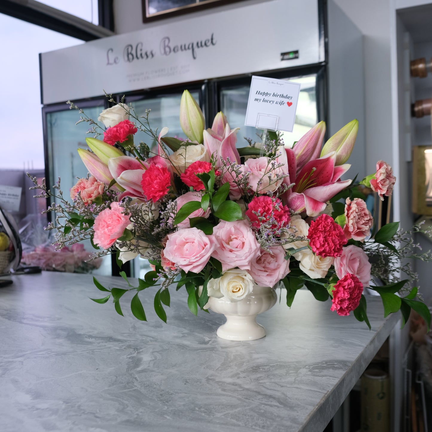 Premium vase arrangement with lilies, rose, and carnation in shades of pink by le bliss bouquet, toko bunga surabaya. bunga meja pengiriman ke surabaya