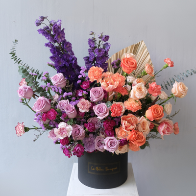 Rangkaian bunga Purple Delphinium dan Orange elegan dalam BloomBox untuk pengiriman ke Bintaro, Jakarta, Cirebon
