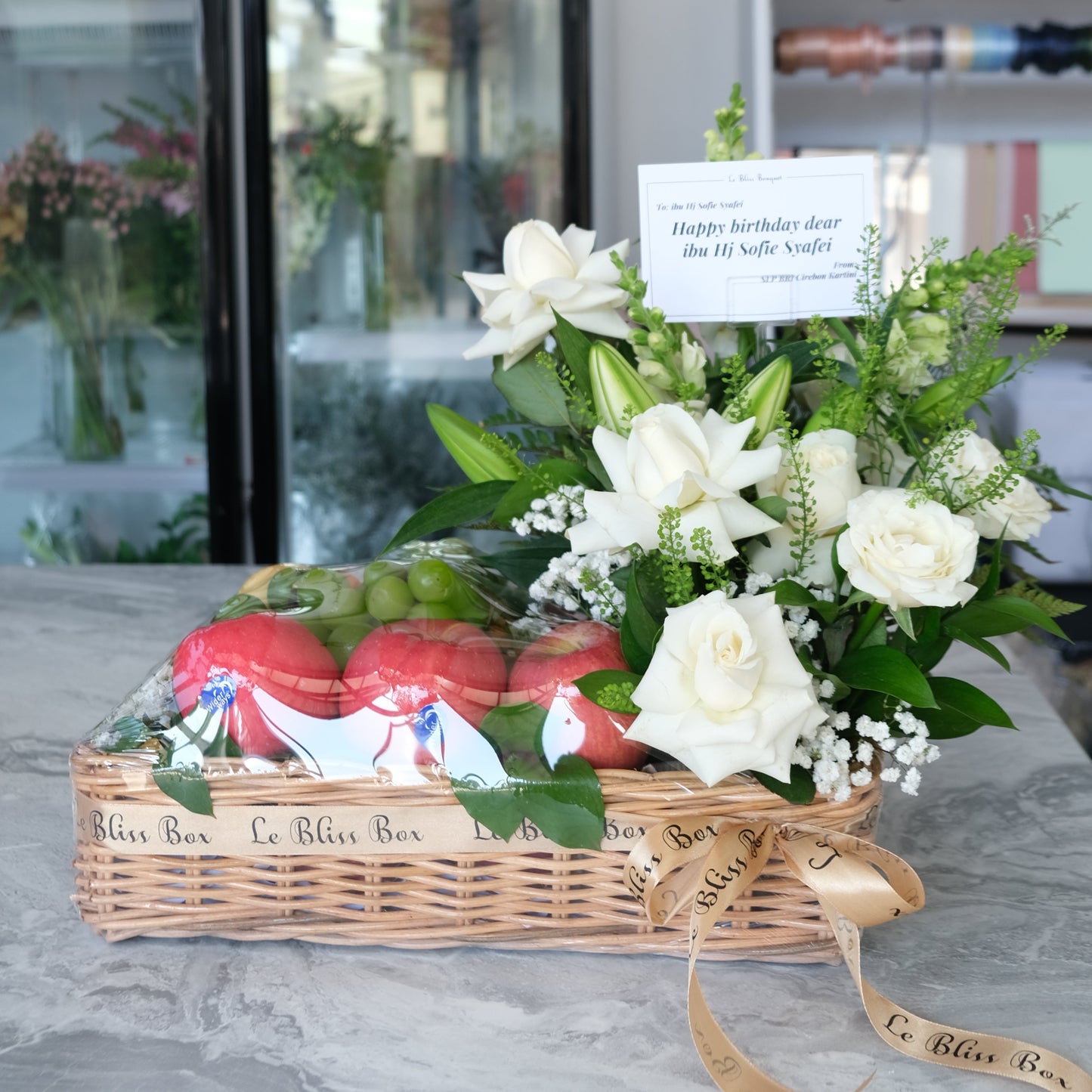 Rattan fruit Parcel with white roses and lilies by le bliss box | parcel buah surabaya, hamper buah surabaya
