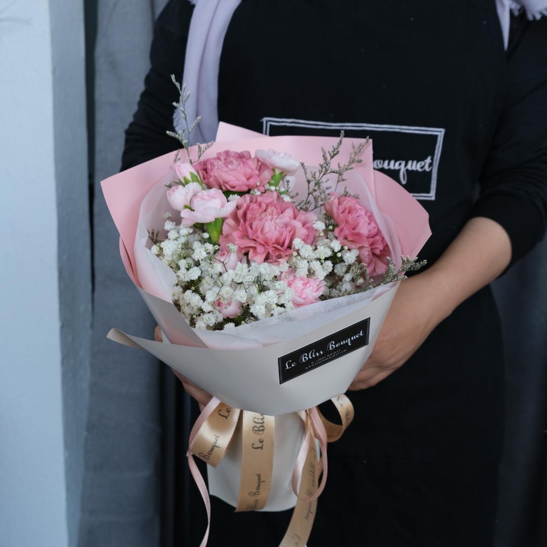 Round bouquet of soft pink carnations with pastel wrapping – sweet flower gift by Le Bliss Bouquet - Florist Surabaya