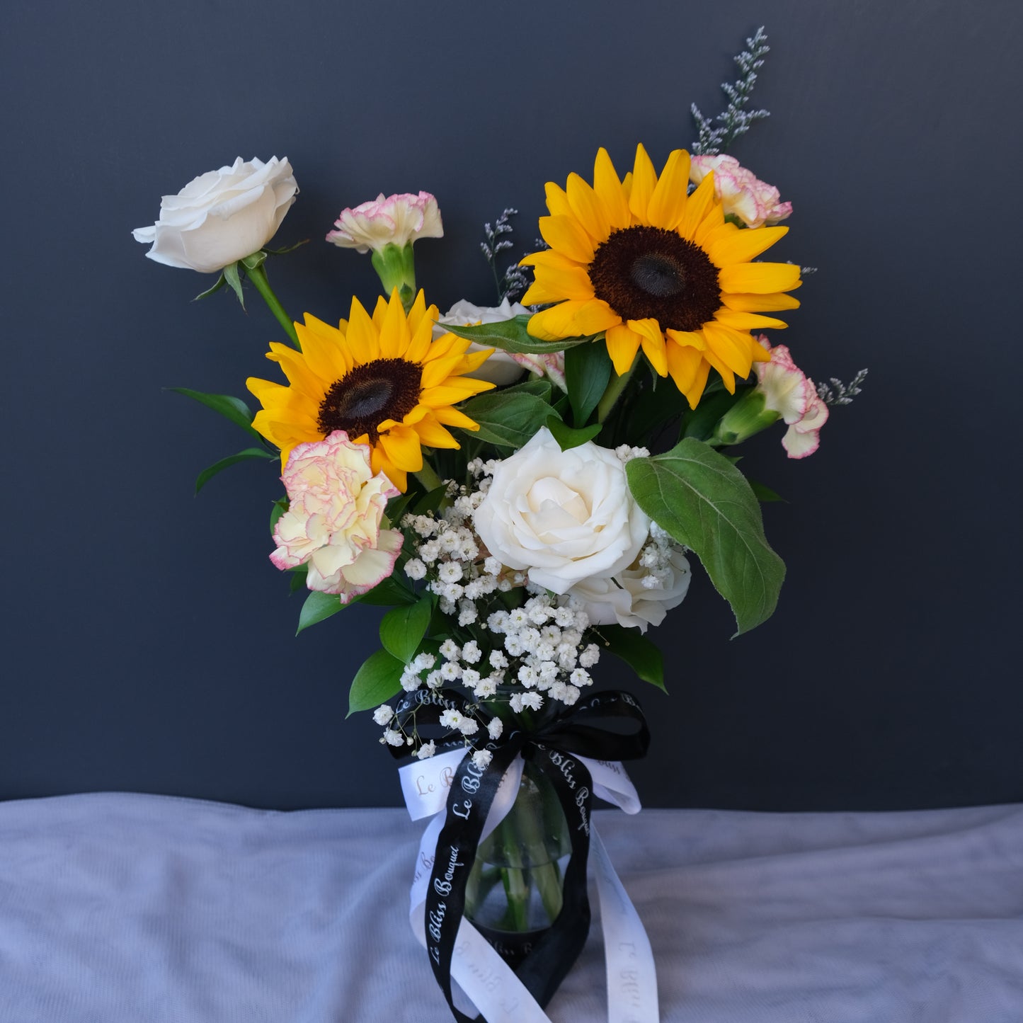 Sunflower bottle arrangement available for delivery in Jakarta, Bintaro, and Cirebon from Le Bliss Bouquet.