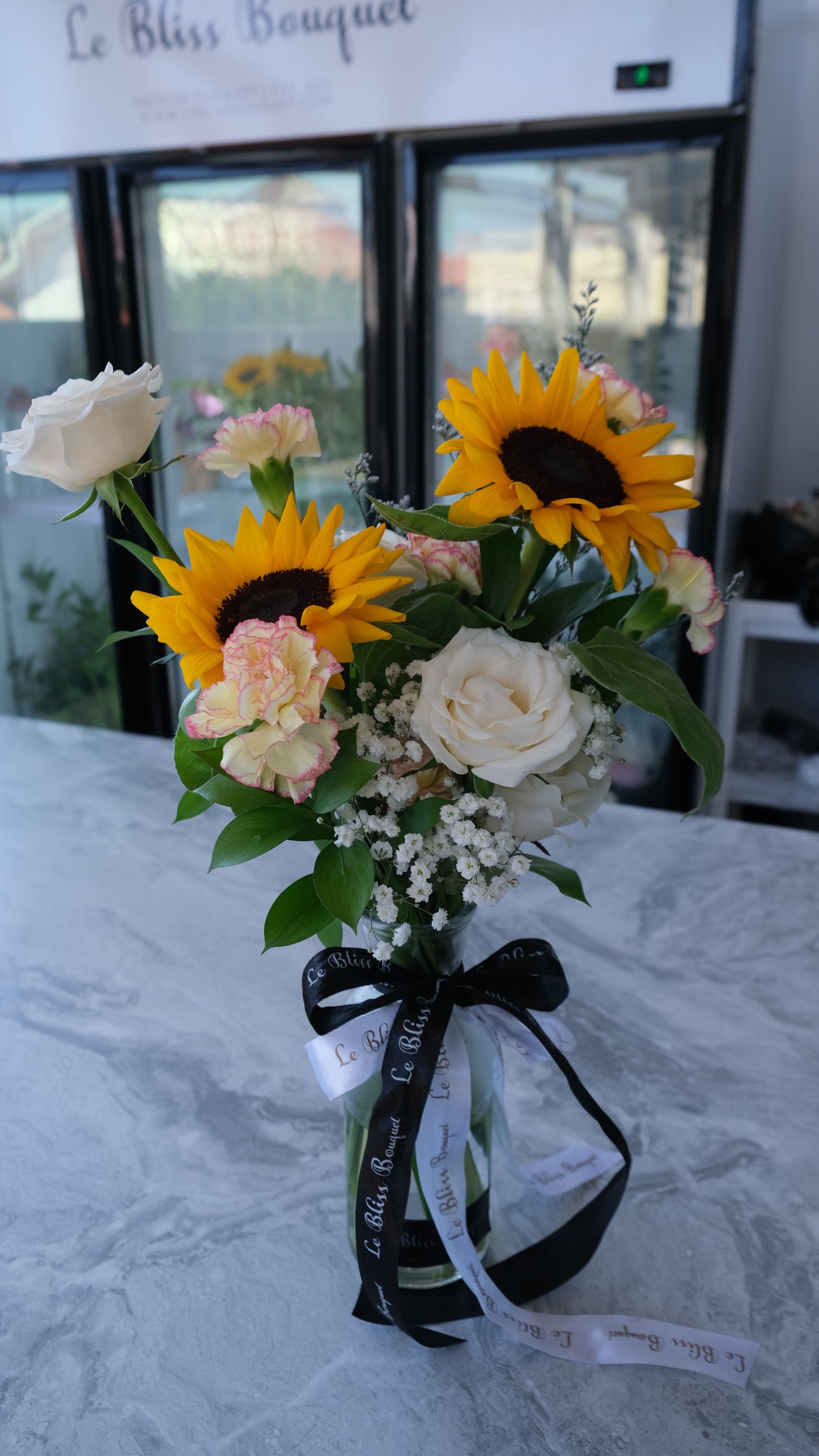 Sunflower bouquet in a bottle available for delivery in Jakarta, Bintaro, and Cirebon from Le Bliss Bouquet.