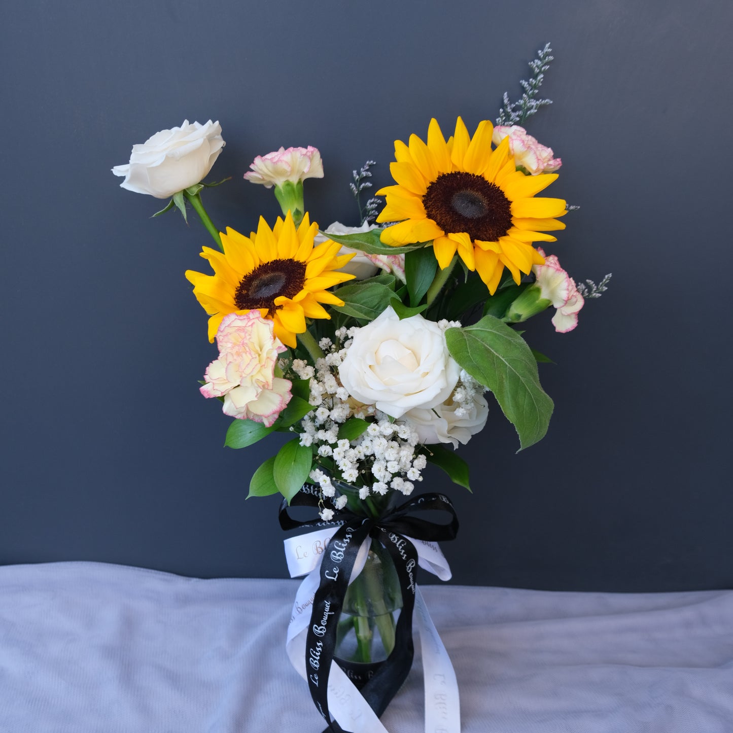Sunflower bouquet in a bottle with rustic yellow blooms, available for delivery in Jakarta, Bintaro, and Cirebon from Le Bliss Bouquet.