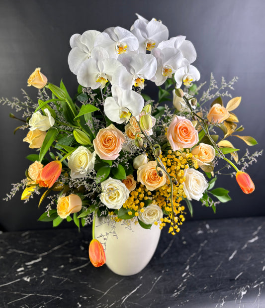 VASE flowers with white orchids, roses, and other flowers in a vase on a dark surface. Florist Jakarta, Surabaya, Cirebon