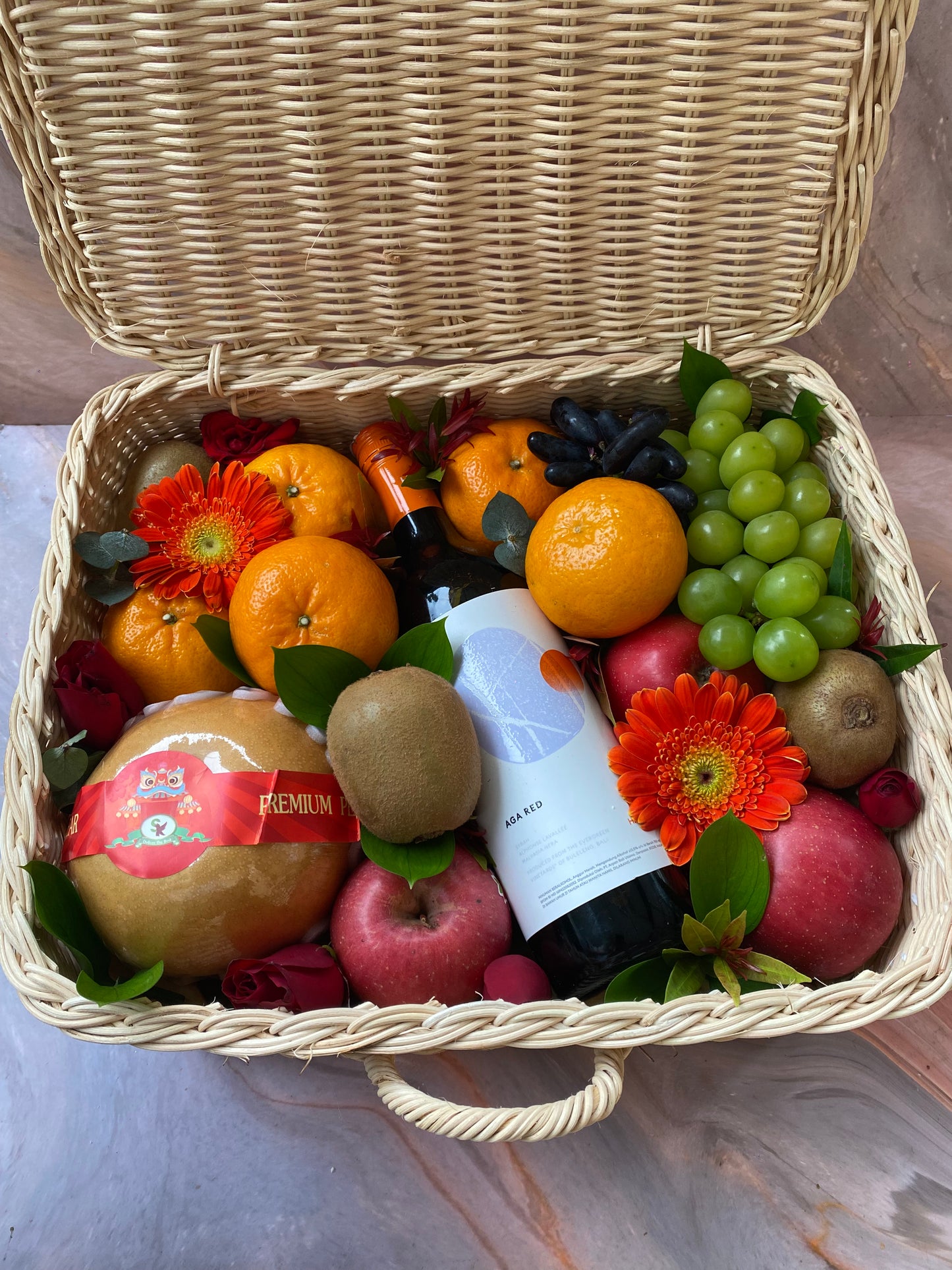 Wine hamper Jakarta berisi buah segar dan bunga segar, wine dalam keranjang rotan premium - jakarta delivery