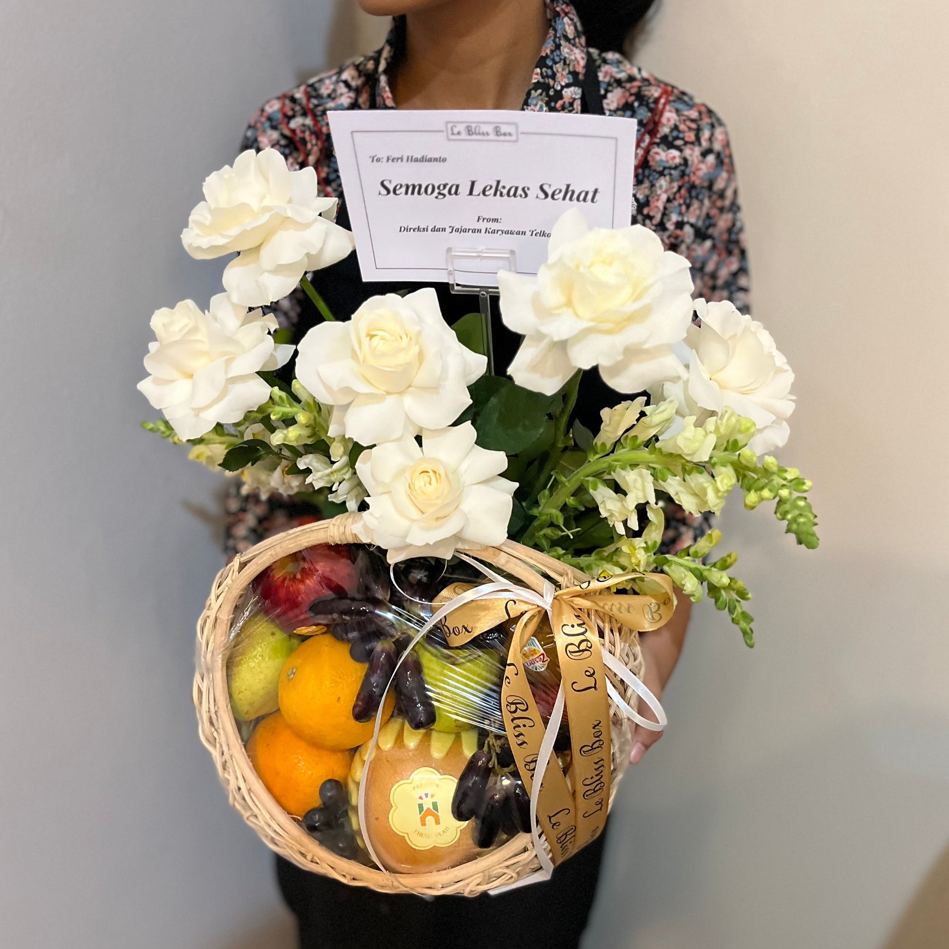  a gift basket containing fresh fruits, grapes, and a white roses. Fruit hamper jakarta, surabaya, cirebon by le bliss box. parcel buah jakarta, parcel buah surabaya