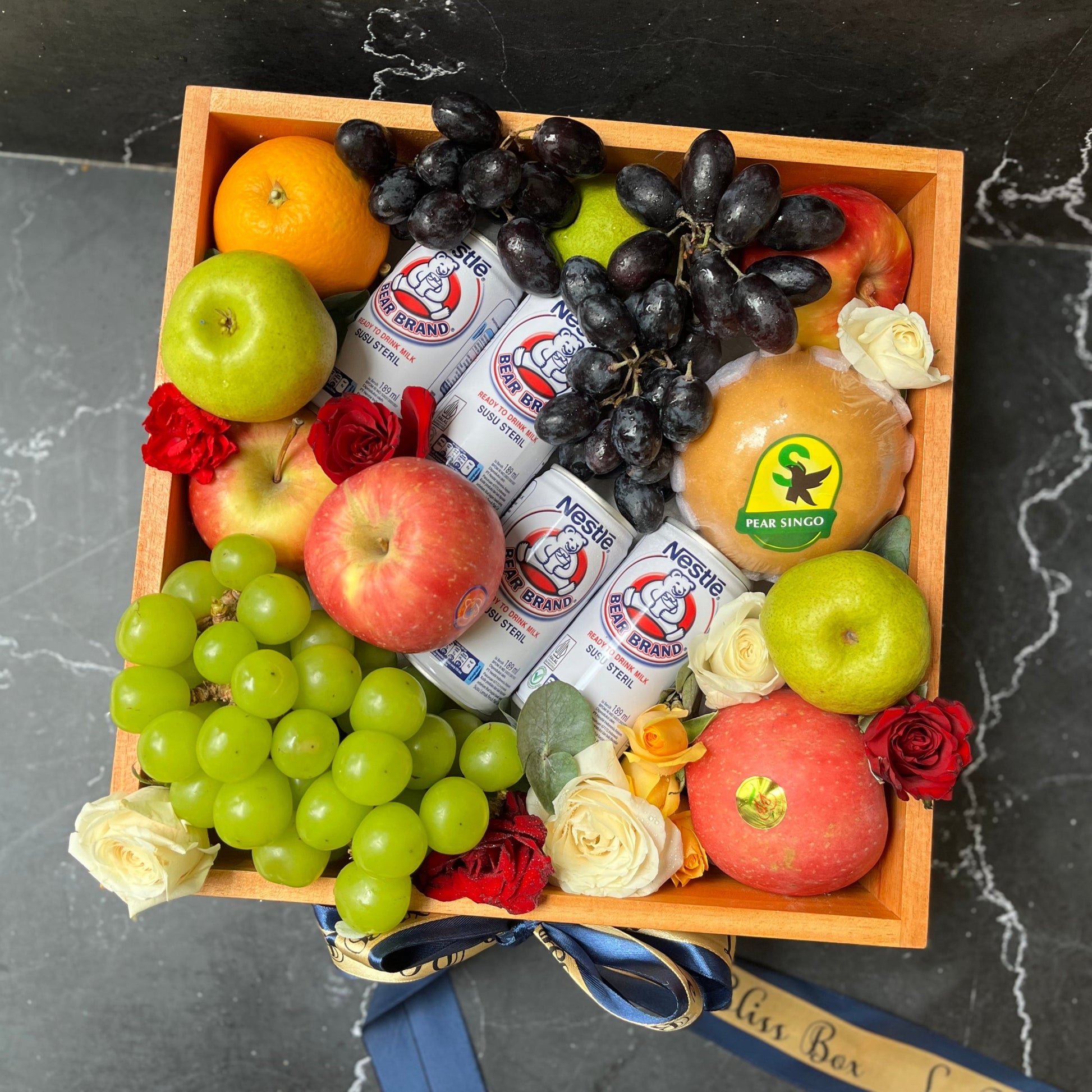 parcel buah jakarta Bear Brand Wooden Fruit Box berisi buah-buahan segar, susu Bear Brand, anggur premium, dan topping bunga segar dalam box kayu elegan. parcel buah surabaya