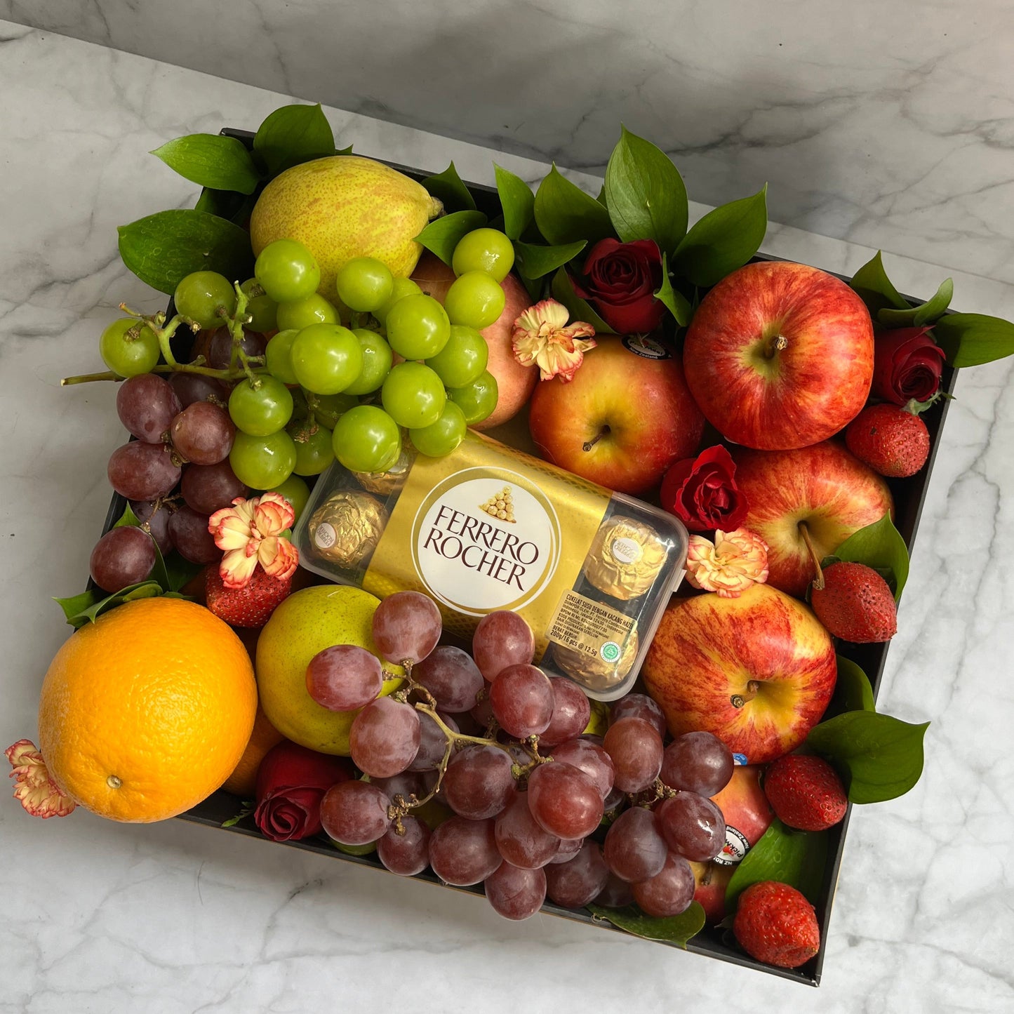 parcel buah jakartafeaturing a fruit box with imported seasonal fruits and Ferrero Rocher chocolates